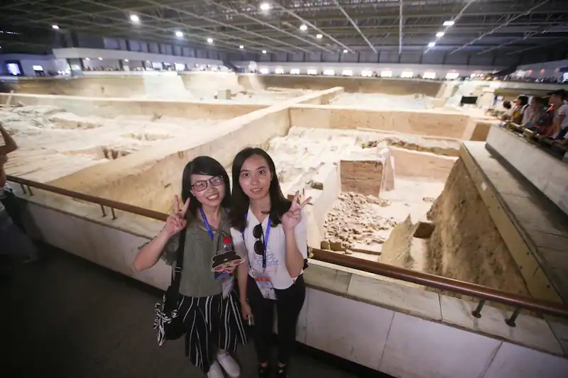 2018 Event - Photo of two girls posing infront of an excavation site